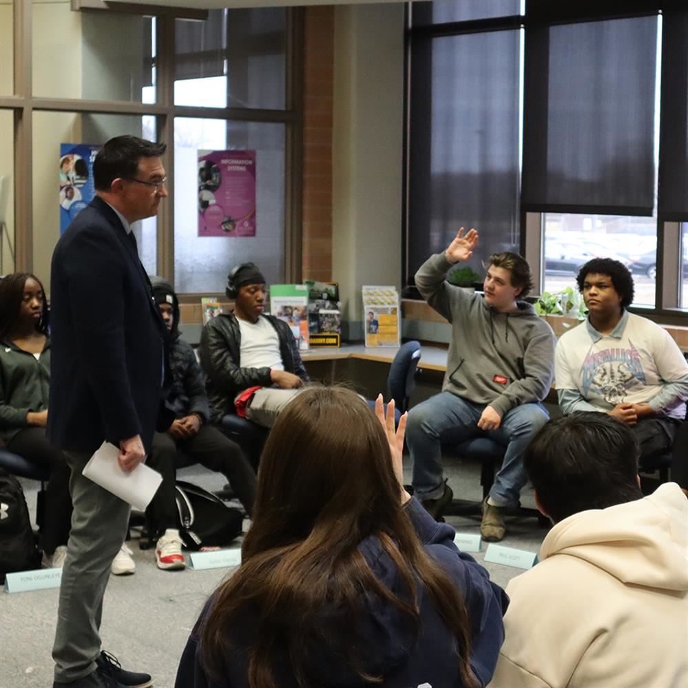 Cory McIntyre visits with students at Champlin Park High School on Feb. 23